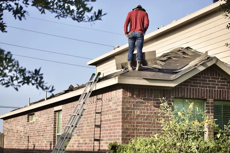 Professional roofer working on a residential roof in Oakbourne